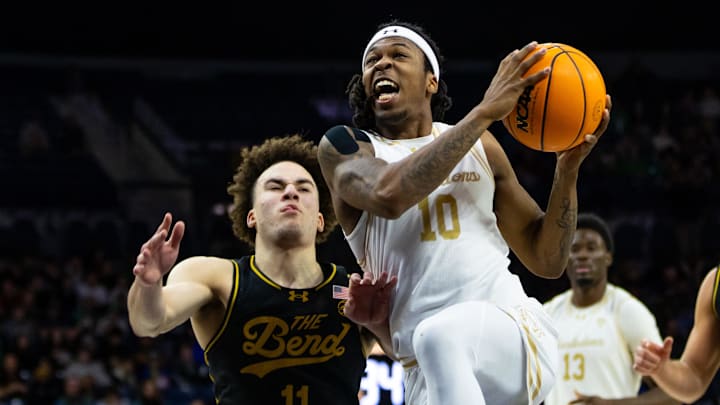 Dec 21, 2025; South Bend, Indiana, USA; Purdue Fort Wayne Mastodons guard Corey Hadnot II (10) drives past Notre Dame Fighting Irish guard Braeden Shrewsberry (11) during the second half at Purcell Pavilion at the Joyce Center. Mandatory Credit: Michael Caterina-Imagn Images