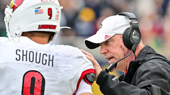 Sep 28, 2024; South Bend, Indiana, USA; Louisville Cardinals head coach Jeff Brohm talks to quarterback Tyler Shough (9) in the second quarter against the Notre Dame Fighting Irish at Notre Dame Stadium. Mandatory Credit: Matt Cashore-Imagn Images