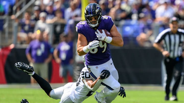 Sep 15, 2024; Baltimore, Maryland, USA; Baltimore Ravens tight end Mark Andrews (89) runs with the ball as Las Vegas Raiders safety Isaiah Pola-Mao (20) attempts to make a tackle during the first half at M&T Bank Stadium. Mandatory Credit: Reggie Hildred-Imagn Images Sep 15, 2024; Baltimore, Maryland, USA; Baltimore Ravens tight end Mark Andrews (89) runs with the ball as Las Vegas Raiders safety Isaiah Pola-Mao (20) attempts to make a tackle during the first half at M&T Bank Stadium. Mandatory Credit: Reggie Hildred-Imagn Images