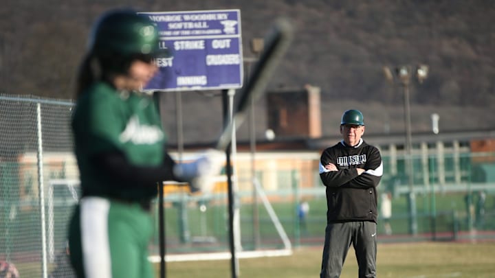 Minisink Valley softball coach Bruce Guyette, right, coaches alongside the third-base line during the 2023 season.