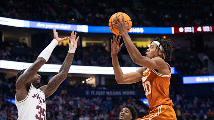 Texas A&M Aggies guard Manny Obaseki (35) guards while Texas Longhorns guard Tre Johnson (20) goes up for a layup during their second round game of the SEC Men's Basketball Tournament at Bridgestone Arena in Nashville, Tenn., Thursday, March 13, 2025. Texas A&M Aggies guard Manny Obaseki (35) guards while Texas Longhorns guard Tre Johnson (20) goes up for a layup during their second round game of the SEC Men's Basketball Tournament at Bridgestone Arena in Nashville, Tenn., Thursday, March 13, 2025.