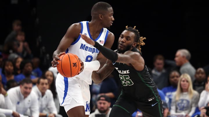 Feb 11, 2024; Memphis, Tennessee, USA; Memphis Tigers forward David Jones (8) handles the ball as Tulane Green Wave guard Jaylen Forbes (25) defends during the second half at FedExForum.