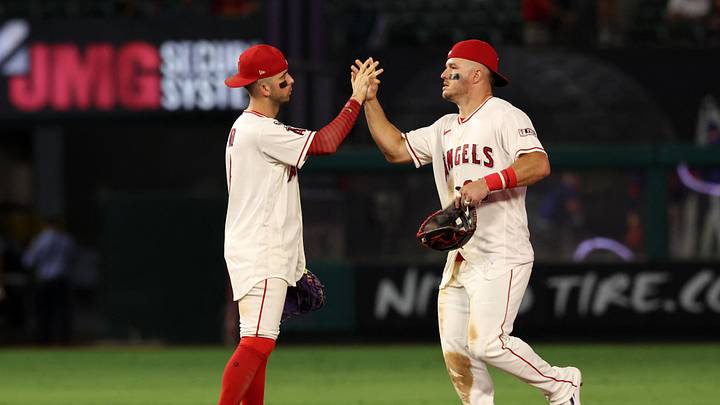 Anaheim, California, USA; Los Angeles Angels shortstop Zach Neto (9) celebrates with center fielder Mike Trout (27) after a 3-2 victory over the Texas Rangers at Angel Stadium. Mandatory Credit: Kiyoshi Mio-Imagn Images