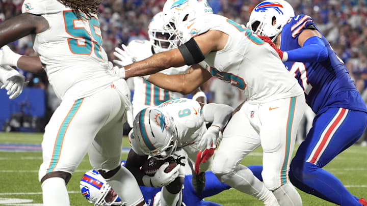 Buffalo Bills cornerback Taron Johnson (7) tackles Miami Dolphins wide receiver Malik Washington (6) in the fourth quarter at Highmark Stadium.