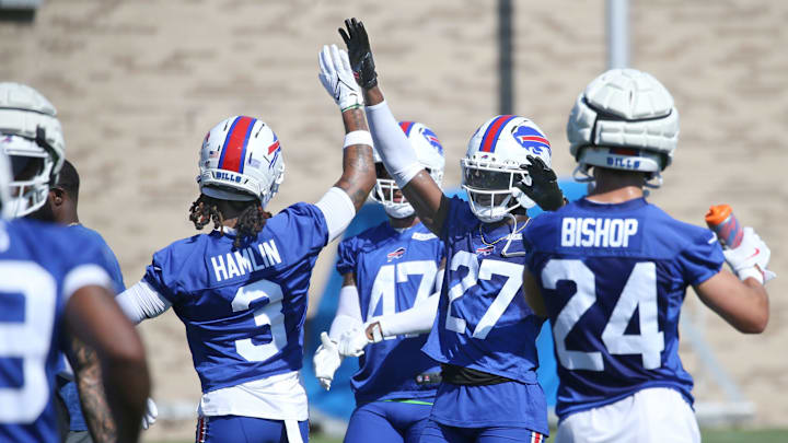 Bills defensive back Tre’Davious White high-fives Damar Hamlin as the unit starts a new set of drills during the opening day of Buffalo Bills training camp at St. John Fisher University Wednesday, July 23, 2025 in Pittsford.