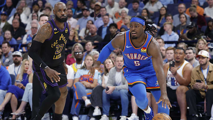 Thunder guard Lu Dort drives past Lakers forward LeBron James during Thursday’s game.