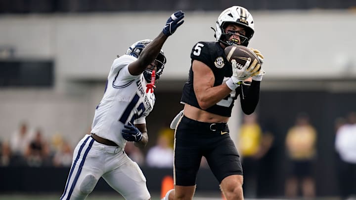 Vanderbilt wide receiver Richie Hoskins (5) receives a pass resulting in a touchdown past Utah State safety Bobby Arnold (12) during the third quarter at FirstBank Stadium in Nashville, Tenn., Saturday, Sept. 27, 2025.