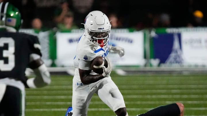 IMG running back Eric McFarland III (#3) runs over Venice defensive back Malec Borrelli (#25). The Venice Indians hosted the IMG Academy Ascenders National team Friday evening Sept. 3, 2025.