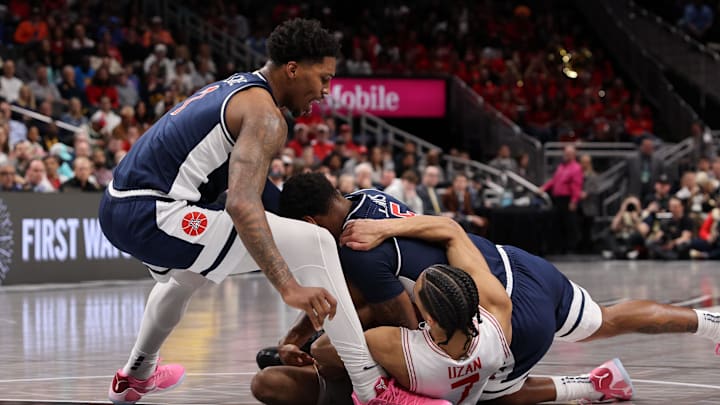 Mar 15, 2025; Kansas City, MO, USA; Arizona Wildcats guard Caleb Love (1), Arizona Wildcats guard KJ Lewis (5) and Houston Cougars guard Milos Uzan (7) attempt to get a loose ball during the first half for the Big 12 Conference Tournament Championship game at T-Mobile Center. Mandatory Credit: William Purnell-Imagn Images