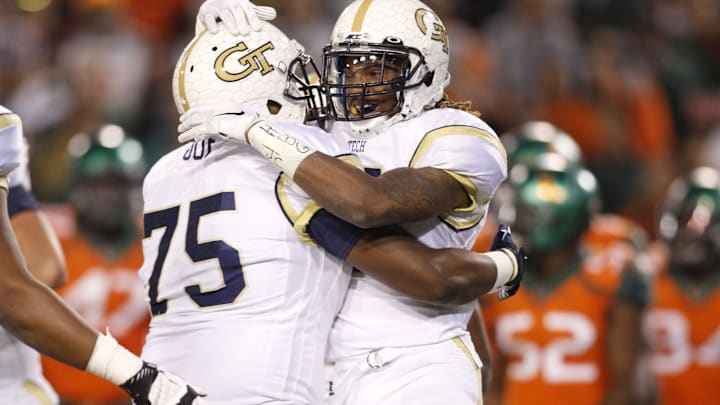 Oct 4, 2014; Atlanta, GA, USA; Georgia Tech Yellow Jackets offensive lineman Errin Joe (75) and running back B.J. Bostic (7) celebrate a touchdown against the Miami Hurricanes in the third quarter at Bobby Dodd Stadium. Georgia Tech defeated Miami 28-17. Mandatory Credit: Brett Davis-Imagn Images