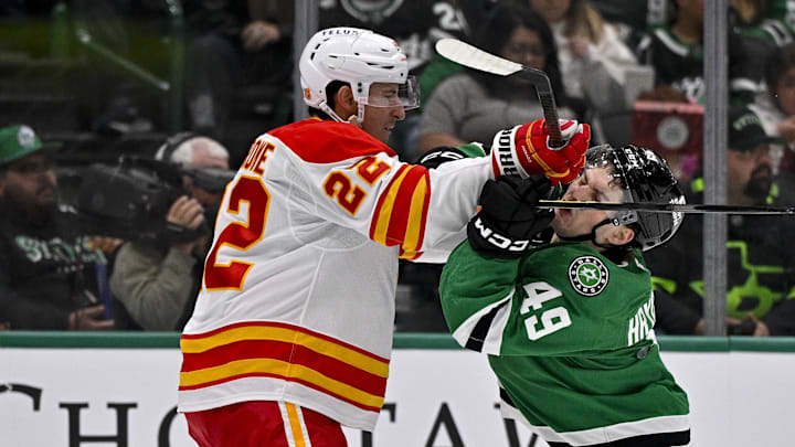 Apr 7, 2026; Dallas, Texas, USA; Calgary Flames center Ryan Strome (22) checks Dallas Stars center Justin Hryckowian (49) during the second period at the American Airlines Center. Mandatory Credit: Jerome Miron-Imagn Images