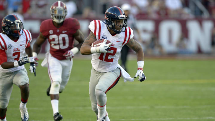Sep 28, 2013; Tuscaloosa, AL, USA; Mississippi Rebels wide receiver Donte Moncrief (12) carries up the field against the Alabama Crimson Tide defense during the first quarter at Bryant-Denny Stadium. Mandatory Credit: John David Mercer-Imagn Images