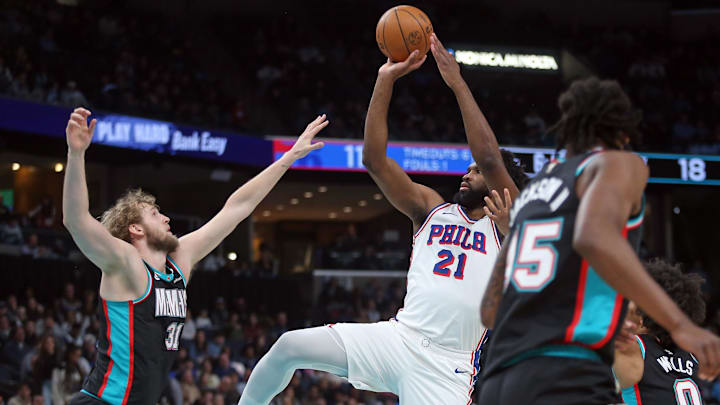 Dec 30, 2025; Memphis, Tennessee, USA; Philadelphia 76ers center Joel Embiid (21) shoots as Memphis Grizzlies center Jock Landale (31) defends during the first quarter at FedExForum. Mandatory Credit: Petre Thomas-Imagn Images
