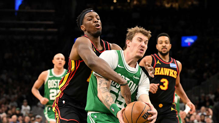 Jan 28, 2026; Boston, Massachusetts, USA; Atlanta Hawks forward Onyeka Okongwu (17) fouls Boston Celtics guard Baylor Scheierman (55) during the second half at the TD Garden. Mandatory Credit: Brian Fluharty-Imagn Images