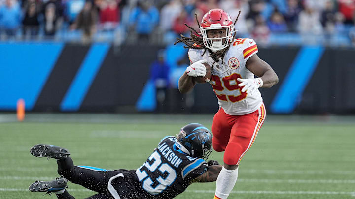 Nov 24, 2024; Charlotte, North Carolina, USA; Kansas City Chiefs running back Kareem Hunt (29) tries to elude Carolina Panthers cornerback Dane Jackson (23) during the second half at Bank of America Stadium. Mandatory Credit: Jim Dedmon-Imagn Images