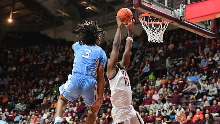 Mar 4, 2025; Blacksburg, Virginia, USA;  Virginia Tech Hokies guard Tyler Johnson (10) goes up for a shot as North Carolina Tar Heels guard Elliot Cadeau (3) defends during the first half at Cassell Coliseum. Mandatory Credit: Brian Bishop-Imagn Images