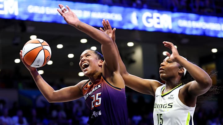 Jul 3, 2025; Arlington, Texas, USA;  Phoenix Mercury forward Alyssa Thomas (25) drives to the basket past Dallas Wings center Teaira McCowan (15) during the second half at College Park Center. Mandatory Credit: Kevin Jairaj-Imagn Images