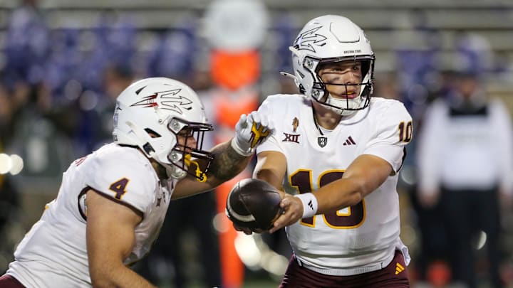 Nov 16, 2024; Manhattan, Kansas, USA; Arizona State Sun Devils quarterback Sam Leavitt (10) hands off to running back Cam Skattebo (4) against the Kansas State Wildcats during the second quarter at Bill Snyder Family Football Stadium. Mandatory Credit: Scott Sewell-Imagn Images