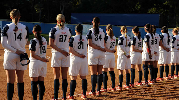 Apr 22, 2008; Los Angeles, CA, USA; USA national team players Monica Abbott (14), Vicky Galindo (19), Jennie Finch (27), Jenny Topping (31), Alicia Hollowell (34), Lauren Lappin (37), Laura Berg (44), Caitlin Lowe (26), Natasha Watley (29) Jessica Mendoza (2) and Crstyl Bustos (6) listen to national anthem before exhibition game against the UCLA Bruins at Easton Field. 