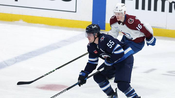 Jan 11, 2025; Winnipeg, Manitoba, CAN; Winnipeg Jets center Mark Scheifele (55) is chased down by Colorado Avalanche center Juuso Parssinen (16) during the third period at Canada Life Centre. Mandatory Credit: James Carey Lauder-Imagn Images