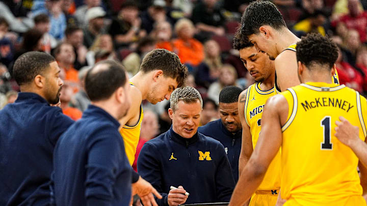 Michigan head coach Dusty May talks to players at a timeout against Wisconsin during the second half of Big Ten Tournament semifinal at United Center in Chicago on Saturday, March 14, 2026.