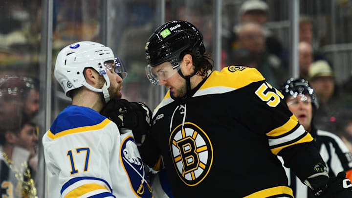 Mar 17, 2025; Boston, Massachusetts, USA;  Boston Bruins defenseman Andrew Peeke (52) grabs a hold of Buffalo Sabres left wing Jason Zucker (17) during the second period at TD Garden. Mandatory Credit: Bob DeChiara-Imagn Images