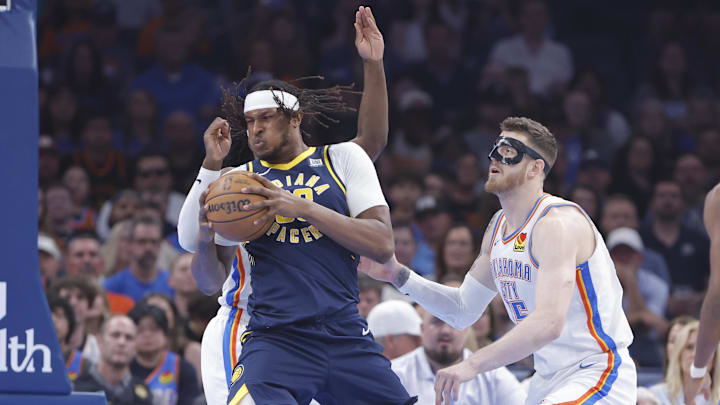 Mar 29, 2025; Oklahoma City, Oklahoma, USA; Indiana Pacers center Myles Turner (33) moves to the basket as Oklahoma City Thunder center Isaiah Hartenstein (55) defends during the first quarter at Paycom Center. Mandatory Credit: Alonzo Adams-Imagn Images