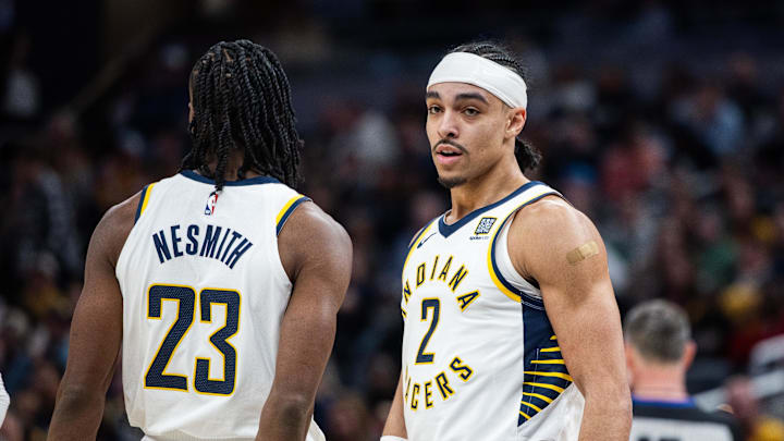 Feb 1, 2025; Indianapolis, Indiana, USA; Indiana Pacers guard Andrew Nembhard (2) celebrates with forward Aaron Nesmith (23) after a foul and basket against the Atlanta Hawks in the second half at Gainbridge Fieldhouse. Mandatory Credit: Trevor Ruszkowski-Imagn Images