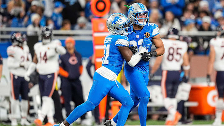 Detroit Lions safety Kerby Joseph (31), left, and safety Brian Branch (32) celebrate a play against Chicago Bears during the first half at Ford Field in Detroit on Thursday, Nov. 28, 2024.