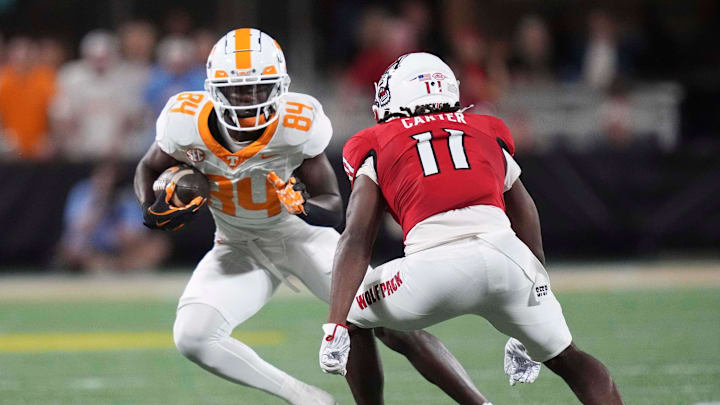 Tennessee wide receiver Kaleb Webb (84) is defended by NC State safety Ja'Had Carter (11) at the NCAA College football game between Tennessee and NC State on Saturday, Sept. 7, 2024 in Charlotte, NC.