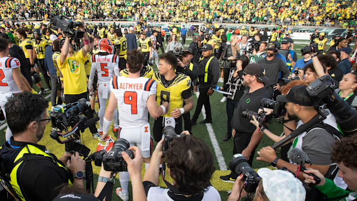 Oregon quarterback Dillon Gabriel and Illinois quarterback Luke Altmyer as the No. 1 Oregon Ducks host the No. 21 Illinois Fighting Illini Saturday, Oct. 26, 2024 at Autzen Stadium in Eugene, Ore. Oregon quarterback Dillon Gabriel and Illinois quarterback Luke Altmyer as the No. 1 Oregon Ducks host the No. 21 Illinois Fighting Illini Saturday, Oct. 26, 2024 at Autzen Stadium in Eugene, Ore.
