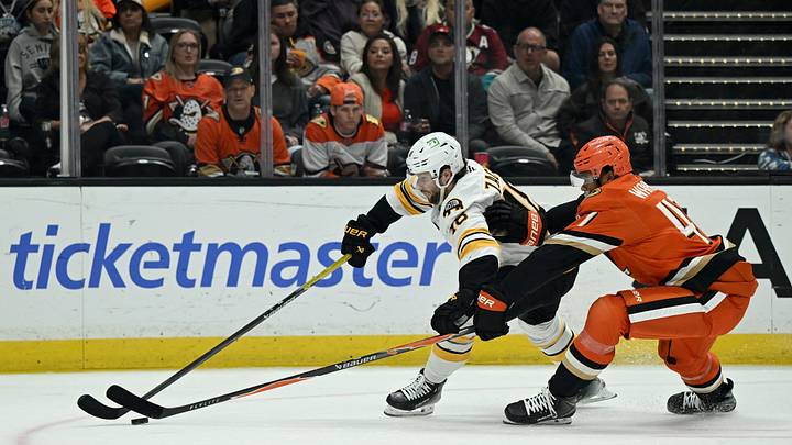 Oct 16, 2026; Anaheim, California, USA;  Boston Bruins center Pavel Zacha (18) skates with the puck against Anaheim Ducks defenseman Noah Warren (47) during the second period at Honda Center.  Mandatory Credit: Griffin Hooper-Imagn Images