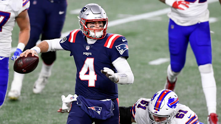 Dec 28, 2020; Foxborough, Massachusetts, USA; New England Patriots quarterback Jarrett Stidham (4) looks to pass under pressure from Buffalo Bills defensive tackle Justin Zimmer (61) during the second half at Gillette Stadium. Mandatory Credit: Brian Fluharty-Imagn Images