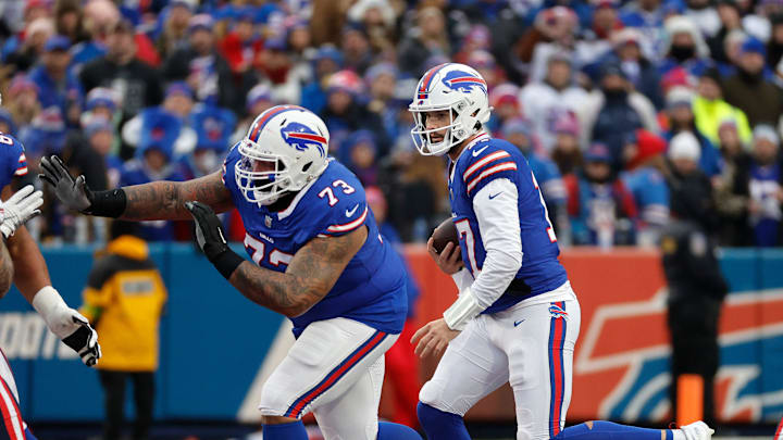 Buffalo Bills quarterback Josh Allen follows a block by Buffalo Bills offensive tackle Dion Dawkins.