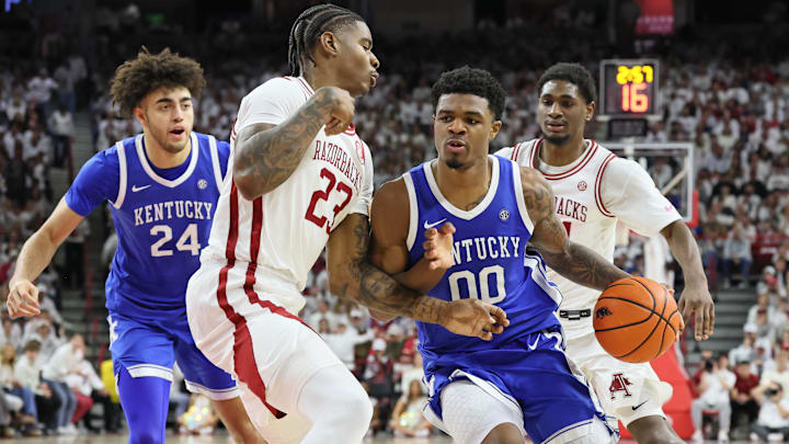 Jan 31, 2026; Fayetteville, Arkansas, USA; Kentucky Wildcats guard Otega Oweh (00) drives against Arkansas Razorbacks forward Nick Pringle (23) during the first half at Bud Walton Arena. Mandatory Credit: Nelson Chenault-Imagn Images Jan 31, 2026; Fayetteville, Arkansas, USA; Kentucky Wildcats guard Otega Oweh (00) drives against Arkansas Razorbacks forward Nick Pringle (23) during the first half at Bud Walton Arena. Mandatory Credit: Nelson Chenault-Imagn Images