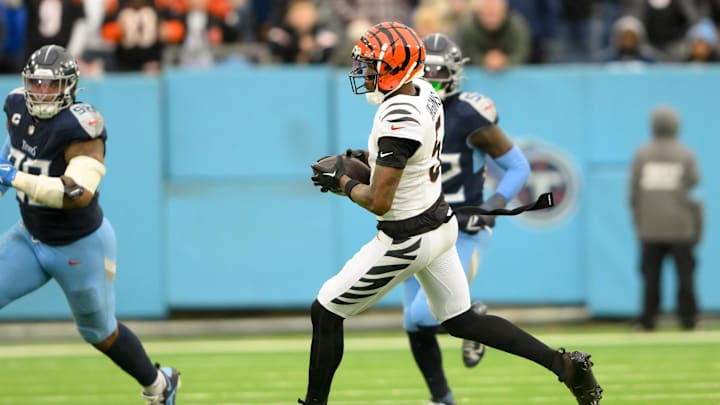 Dec 15, 2024; Nashville, Tennessee, USA;  Cincinnati Bengals wide receiver Tee Higgins (5) runs with the ball after a made catch against the Tennessee Titans during the second half at Nissan Stadium. Mandatory Credit: Steve Roberts-Imagn Images