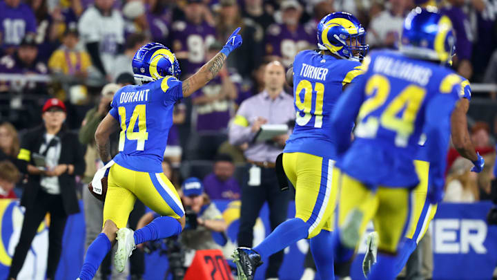 Jan 13, 2025; Glendale, AZ, USA; Los Angeles Rams cornerback Cobie Durant (14) recovers a fumble against the Minnesota Vikings during the first half in an NFC wild card game at State Farm Stadium. Mandatory Credit: Mark J. Rebilas-Imagn Images