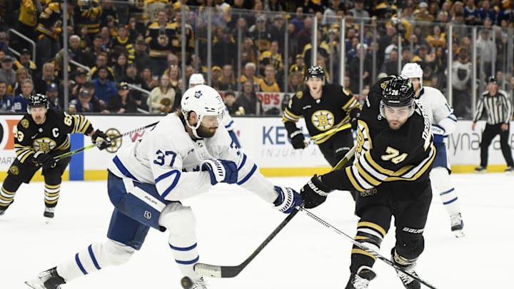 May 4, 2024; Boston, Massachusetts, USA; Boston Bruins left wing Jake DeBrusk (74) shoots the puck while Toronto Maple Leafs defenseman Timothy Liljegren (37) defends during the third period in game seven of the first round of the 2024 Stanley Cup Playoffs at TD Garden. Mandatory Credit: Bob DeChiara-Imagn Images