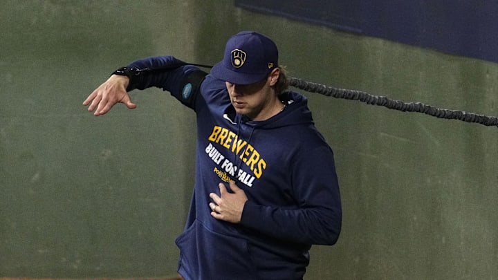Oct 14, 2025; Milwaukee, Wisconsin, USA; Milwaukee Brewers pitcher Trevor Megill (29) stretches in the bullpen against the Los Angeles Dodgers in the ninth inning during game two of the NLCS round for the 2025 MLB playoffs at American Family Field. Mandatory Credit: Michael McLoone-Imagn Images
