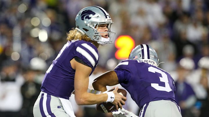 Nov 16, 2024; Manhattan, Kansas, USA; Kansas State Wildcats quarterback Avery Johnson (2) fakes a handoff to running back Dylan Edwards (3) during the first quarter against the Arizona State Sun Devils at Bill Snyder Family Football Stadium. Mandatory Credit: Scott Sewell-Imagn Images