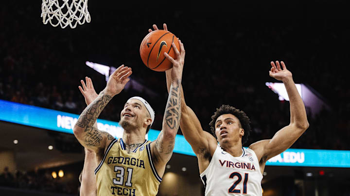 Feb 8, 2025; Charlottesville, Virginia, USA; Georgia Tech Yellow Jackets forward Duncan Powell (31) shoots the ball while Virginia Cavaliers forward Anthony Robinson (21) defends during the second half at John Paul Jones Arena. Mandatory Credit: Emily Faith Morgan-Imagn Images Feb 8, 2025; Charlottesville, Virginia, USA; Georgia Tech Yellow Jackets forward Duncan Powell (31) shoots the ball while Virginia Cavaliers forward Anthony Robinson (21) defends during the second half at John Paul Jones Arena. Mandatory Credit: Emily Faith Morgan-Imagn Images