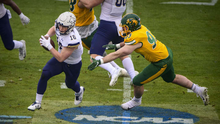 Jan 8, 2022; Frisco, TX, USA; Montana State Bobcats quarterback Tommy Mellott (16) eludes North Dakota State Bison defensive end Logan McCormick (93) during the first half of the FCS Championship at Toyota Stadium. Mandatory Credit: Jerome Miron-Imagn Images Jan 8, 2022; Frisco, TX, USA; Montana State Bobcats quarterback Tommy Mellott (16) eludes North Dakota State Bison defensive end Logan McCormick (93) during the first half of the FCS Championship at Toyota Stadium. Mandatory Credit: Jerome Miron-Imagn Images