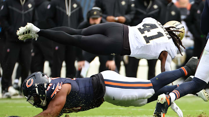 Oct 19, 2025; Chicago, Illinois, USA; New Orleans Saints running back Alvin Kamara (41) dives for a first down against the Chicago Bears during the second half at Soldier Field. Mandatory Credit: Mike Dinovo-Imagn Images