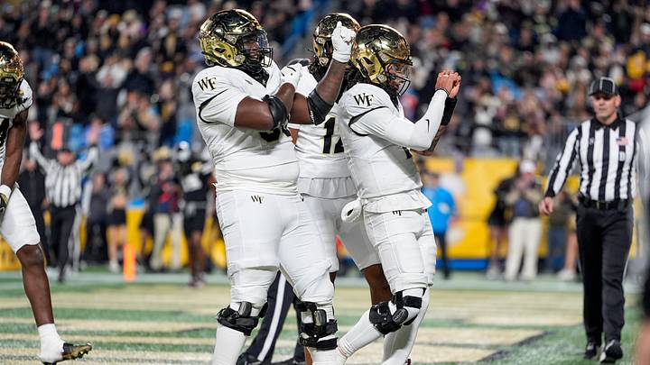 Jan 2, 2026; Charlotte, NC, USA; Wake Forest Demon Deacons quarterback Robby Ashford (2) and a couple of his linemen celebrate a touchdown during the second half against the Mississippi State Bulldogs at Bank of America Stadium. Mandatory Credit: Jim Dedmon-Imagn Images Jan 2, 2026; Charlotte, NC, USA; Wake Forest Demon Deacons quarterback Robby Ashford (2) and a couple of his linemen celebrate a touchdown during the second half against the Mississippi State Bulldogs at Bank of America Stadium. Mandatory Credit: Jim Dedmon-Imagn Images