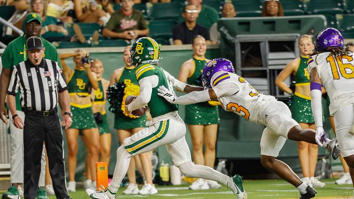 Sep 12, 2026; Waco, Texas, USA; Baylor Bears quarterback Nate Bennett (12) carries the ball for a touchdown against Prairie View A&M Panthers safety Corey Thompson, Jr. (33) during the first half at McLane Stadium. Mandatory Credit: Chris Jones-Imagn Images Sep 12, 2026; Waco, Texas, USA; Baylor Bears quarterback Nate Bennett (12) carries the ball for a touchdown against Prairie View A&M Panthers safety Corey Thompson, Jr. (33) during the first half at McLane Stadium. Mandatory Credit: Chris Jones-Imagn Images