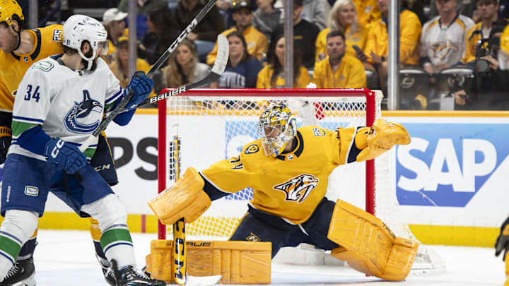 May 3, 2024; Nashville, Tennessee, USA; during the second period in game six of the first round of the 2024 Stanley Cup Playoffs at Bridgestone Arena. Mandatory Credit: Steve Roberts-USA TODAY SportsNashville Predators goaltender Juuse Saros (74) blocks the puck against the Vancouver Canucks 