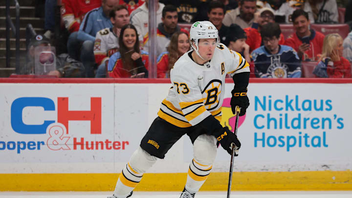 Apr 2, 2026; Sunrise, Florida, USA; Boston Bruins defenseman Charlie McAvoy (73) moves the puck against the Florida Panthers during the first period at Amerant Bank Arena. Mandatory Credit: Sam Navarro-Imagn Images