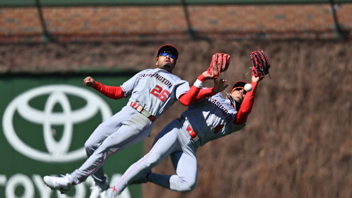 Mar 28, 2026; Chicago, Illinois, USA; Washington Nationals left fielder Daylen Lile (4) and shortstop Nasim Nunez (26) collide causing an error which allows two runs against the Chicago Cubs during the second inning at Wrigley Field. Mandatory Credit: Patrick Gorski-Imagn Images