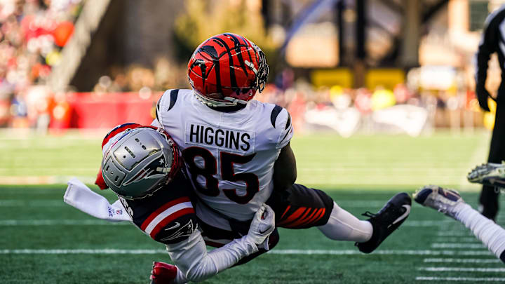 Dec 24, 2022; Foxborough, Massachusetts, USA; Cincinnati Bengals wide receiver Tee Higgins (85) makes a touchdown against New England Patriots cornerback Jonathan Jones (31) in the first quarter at Gillette Stadium. Mandatory Credit: David Butler II-Imagn Images
