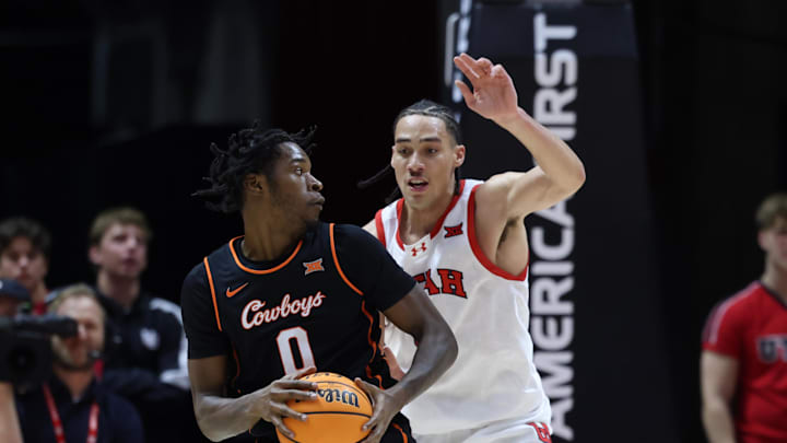 Jan 11, 2025; Salt Lake City, Utah, USA; Oklahoma State Cowboys forward Marchelus Avery (0) moves the ball against Utah Utes forward Keanu Dawes (8) during the second half at Jon M. Huntsman Center. Mandatory Credit: Rob Gray-Imagn Images Jan 11, 2025; Salt Lake City, Utah, USA; Oklahoma State Cowboys forward Marchelus Avery (0) moves the ball against Utah Utes forward Keanu Dawes (8) during the second half at Jon M. Huntsman Center. Mandatory Credit: Rob Gray-Imagn Images
